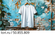 Mock up white t-shirt for logo, text or design. The T-shirt is on a hanger on a shabby background. Copy space. Стоковое AI-изображение, AI-художник Юлия Ильина / Фотобанк Лори