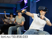 Man using virtual reality glasses delighted with videogames and new tech. Стоковое фото, фотограф Яков Филимонов / Фотобанк Лори