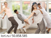 Young girl standing performs basic hip hop movements in front of group of students. Стоковое фото, фотограф Яков Филимонов / Фотобанк Лори