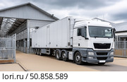 Delivery truck arriving at warehouse during overcast daytime. Стоковое AI-изображение, AI-художник Katsiaryna Repich / Фотобанк Лори