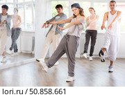 Young girl practicing kicking move of hip hop in training hall. Стоковое фото, фотограф Яков Филимонов / Фотобанк Лори