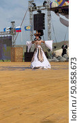 ELANTSY, IRKUTSK REGION, RUSSIA - July 5, 2025: Erdynskie Games - festival of nomadic peoples of Eurasia. Vertical video of Buryat girl demonstrates traditional folk women's historical costume on open stage on summer holidays. Редакционное видео, видеограф Виктория Катьянова / Фотобанк Лори