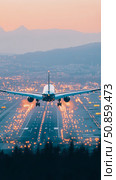 Night Arrival: Passenger airliner descends onto a brightly lit runway, illuminating a city nestled against a mountain range. Стоковое AI-изображение, AI-художник Данила Большаков / Фотобанк Лори