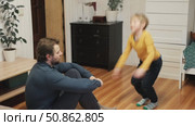 Caucasian bearded strong father with one child boy doing push ups on floor in living room. Family fitness gym at home. Sporty dad and son piggy back having fun exercise. Funny sport with kid. 4k video. Стоковое видео, видеограф Марина Демидюк / Фотобанк Лори