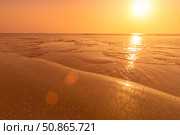 A colorful sunset or sunrise on the seaside with a sandy beach with impurities of volcanic ash. Mandrem, Goa, India. (2018 год). Стоковое фото, фотограф Емельянов Евгений Викторович / Фотобанк Лори
