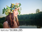 Celebrating Ivan Kupala with a floral wreath by the river at sunset. Стоковое фото, фотограф Кривошеина Елена Леонидовна / Фотобанк Лори