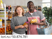 African man with European wife choosing packages of pasta and spaghetti. Стоковое фото, фотограф Яков Филимонов / Фотобанк Лори