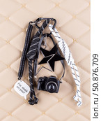 Close-up of a collection of black keychains shaped like cameras, complemented by decorative cords and beads. Стоковое фото, фотограф Виталий Сова / Фотобанк Лори