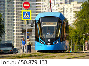 A blue tram car on Stromynka Street against the background of a high-rise building in the distance. Russia. Moscow. 07/25/25. Редакционное фото, фотограф Ярославский Максим / Фотобанк Лори