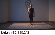 Yoga practitioner performing tadasana pose on studio carpet, minimalist space featuring kundalini serpent symbol creating meditative spiritual environment. Стоковое AI-видео, аниматор Данил Руденко / Фотобанк Лори