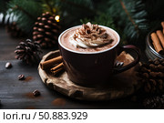 Steaming mug of hot chocolate with whipped cream and cinnamon sticks on wooden tray for christmas. Стоковое AI-изображение, AI-художник Иван Рябоконь / Фотобанк Лори