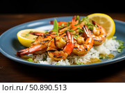 Grilled shrimps with rice and lemon wedges garnished with herbs on blue plate. Стоковое AI-изображение, AI-художник Иван Рябоконь / Фотобанк Лори