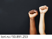 Two fists raised in solidarity against black background. Стоковое AI-изображение, AI-художник Иван Рябоконь / Фотобанк Лори
