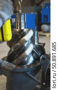 Technician placing screw compressor rotor into housing. Стоковое видео, видеограф Юрий Поздников / Фотобанк Лори