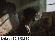 Creative artist working in a sunlit studio surrounded by canvases and tools during the golden hour. Стоковое AI-изображение, AI-художник Сергей Толмачёв / Фотобанк Лори