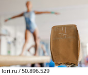 Pommel horse in a gymnasium. In the background, gymnast girl is training on pommel horse. Стоковое фото, фотограф Татьяна Яцевич / Фотобанк Лори