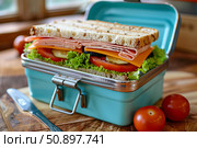 Tasty sandwich prepared for lunch in metal lunchbox. Стоковое AI-изображение, AI-художник Иван Рябоконь / Фотобанк Лори