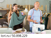 Dissatisfied female client with dress quarrels with tailor. Стоковое фото, фотограф Яков Филимонов / Фотобанк Лори