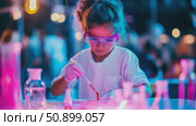 Young scientist conducting a chemical experiment, illuminated by vibrant neon lights in an imaginative laboratory setting. Стоковое AI-видео, аниматор Данила Большаков / Фотобанк Лори
