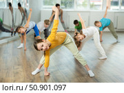 Girl learn to dance hip hop dances, doing movement with unrecognizable teacher. Стоковое фото, фотограф Яков Филимонов / Фотобанк Лори