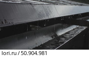 Rainwater streams from roof into a gutter during heavy rainfall. close-up of water drainage system in action on a rainy day. Стоковое видео, видеограф Анастасия Ли / Фотобанк Лори