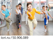 Children studying modern style dances with female teacher in dance class. Стоковое фото, фотограф Яков Филимонов / Фотобанк Лори