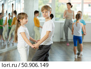Girl paired up with boy and training to perform slow couple dance, rehearse performance. Стоковое фото, фотограф Яков Филимонов / Фотобанк Лори