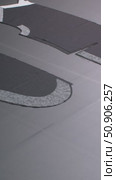Details of a man's black jacket laid out on a tape for dubbing at a garment factory. Стоковое видео, видеограф Дмитрий Нечаев / Фотобанк Лори