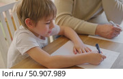 Dad teaches his son writing and counting. Kids primary education. Children learn, study in home school. Daddy male helping teaching little child boy support studying, learning homework. Knowledge day. Стоковое видео, видеограф Марина Демидюк / Фотобанк Лори