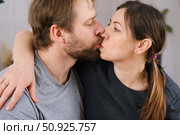 Mature couple hugging hugging each other kissing at home bedroom. Intimate Moment. Tender embrace shared between a loving middle age man and woman, husband and wife. Deep love. Low key, cinematic. Стоковое фото, фотограф Марина Демидюк / Фотобанк Лори