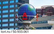 Moscow July 25 2025, Alfa Bank logo a recognizable blue globe displayed prominently outside the bank. Редакционное фото, фотограф Скрипачев Антон / Фотобанк Лори