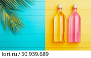Summer Refreshment Concept: Bottled Drinks on a Vibrant Two-Toned Plank Surface for Print, Card, Poster. Стоковое AI-изображение, AI-художник Данила Большаков / Фотобанк Лори