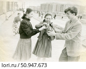 Трое подростков достают хлеб из сумки на улице советского города. Стоковое фото, фотограф Retro / Фотобанк Лори