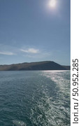 Baikal Lake on summer day. Vertical video of a path of sunbeams on the blue water of the Olkhon Gate Strait from a ferry. Natural water background. Summer cruises and travels. Стоковое видео, видеограф Виктория Катьянова / Фотобанк Лори