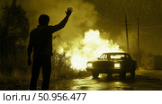 Desperate plea for aid on a rain-soaked rural road, with a lone person silhouetted against a car and golden conflagration, conveying an urgent survival concept. Стоковое AI-изображение, AI-художник Данила Большаков / Фотобанк Лори