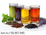 Glasses of tea with different types and colors infused with herbs, on a white background. The teas are green, black, red, purple, and yellow oolong, with loose leaf tea leaves with mint and lavender. Стоковое AI-изображение, AI-художник Марина Демидюк / Фотобанк Лори