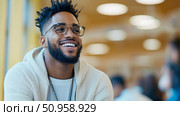 A happy young African man with glasses and dreadlocks smiles brightly in a modern setting, suitable for professional or educational content creation. Стоковое AI-изображение, AI-художник Данила Большаков / Фотобанк Лори