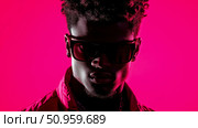 A captivating portrait of a man with sunglasses and dreadlocks, bathed in vibrant neon magenta light, perfect for music album covers or creative promotion. Стоковое AI-изображение, AI-художник Данила Большаков / Фотобанк Лори