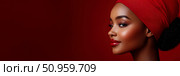 Elegant profile of a woman with radiant red lips and a coordinating head covering against a rich crimson hue, ideal for beauty promotion. Стоковое AI-изображение, AI-художник Данила Большаков / Фотобанк Лори