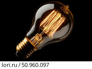Glowing Yellow Light Bulb. Illuminated Light bulb on dark black background banner. Creative Technology. Vintage Edison Bulbs. Warm Illumination in a night space. New idea, brainstorming concept. Стоковое AI-изображение, AI-художник Марина Демидюк / Фотобанк Лори