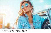 A stylish young woman with mirrored sunglasses and a denim jacket, enjoying a sunny summer road trip adventure. Стоковое AI-изображение, AI-художник Данила Большаков / Фотобанк Лори