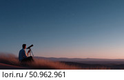 Stargazer observes the night sky with a telescope from a hilltop at dusk in a tranquil setting. Стоковое AI-изображение, AI-художник Сергей Толмачёв / Фотобанк Лори