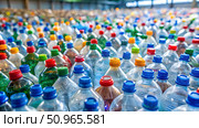 Plastic bottles of water for sale in a factory. Recycling and environmental concept. Стоковое AI-изображение, AI-художник Дмитрий Нечаев / Фотобанк Лори