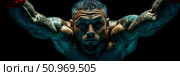 Dynamic close-up of a formidable fighter with an intense gaze, showcasing a heavily tattooed and muscular physique with arms outstretched in a powerful, aqua-toned ascent against a dark background. Стоковое AI-изображение, AI-художник Данила Большаков / Фотобанк Лори