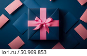 Elegant dark blue gift box with a prominent fuchsia pink ribbon and bow, artfully arranged amidst scattered coordinating blue and pastel pink rectangular cards on a rich navy background, embodying modern gifting. Стоковое AI-изображение, AI-художник Данила Большаков / Фотобанк Лори