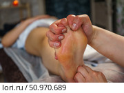 Natural medicine, reflexology, woman receiving foot massage, oppresses energy flow points, spa center calm interior. Стоковое фото, фотограф Владислав Тригуб / Фотобанк Лори