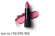Bright pink lipstick placed on a smear of matching color on a white background. Стоковое AI-изображение, AI-художник Katsiaryna Repich / Фотобанк Лори