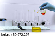 A laboratory assistant does a chemical analysis of water for hardness. Стоковое фото, фотограф lyudmila Soloveva / Фотобанк Лори