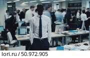 Confident businessman standing amid busy office, embodying professional leadership and calm composure while surrounded by dynamic workplace activity. Стоковое AI-видео, аниматор Данил Руденко / Фотобанк Лори