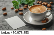 Warm cup of creamy latte with delicate foam art, surrounded by scattered roasted coffee beans and a blank note card on a dark stone surface. Стоковое AI-видео, аниматор Данила Большаков / Фотобанк Лори